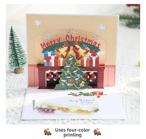 Macro shot of 3D Christmas card showing laser-cut fireplace and festive tree details