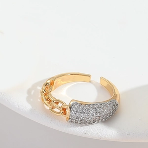 Macro shot of two-tone adjustable ring featuring half chain and half micro-pave zircon detail