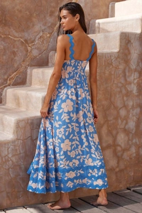 Detailed view of blue floral print maxi dress featuring backless strap design and textured fabric