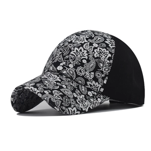 Detail of paisley print baseball cap showing black and white patterns and curved brim