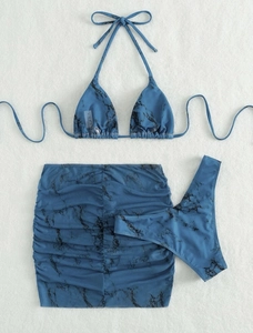 Detailed flat lay of blue marble print 3-piece bikini set with matching drawstring skirt