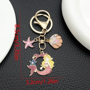 Porte-clés sirène rose en émail avec breloques coquillage et étoile de mer dorées