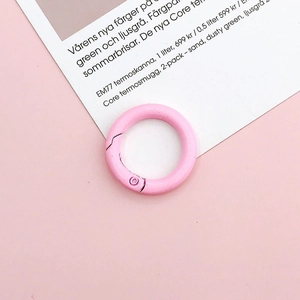 Detailed view of pink 25mm round spring buckle and alloy snap hook for DIY jewelry