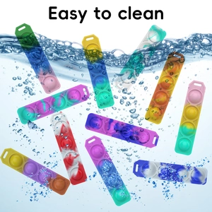 Macro view of colorful silicone Pop It sensory toy floating in water with air bubbles