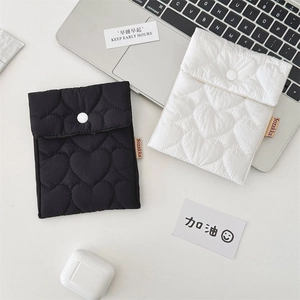 Detail of heart quilted storage pouch set with button closure and brand label