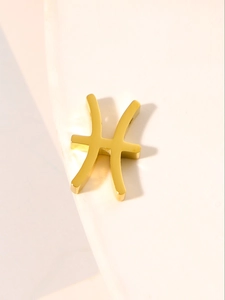 Detailed view of a gold Pisces zodiac pendant with a polished metallic finish