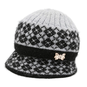 Winter knitted bucket hat for elderly women with jacquard pattern and bow brooch