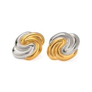 Macro view of two-tone spiral stud earrings in gold and silver polished stainless steel