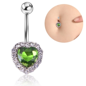 Close-up of silver heart belly button ring with green zircon and sparkling crystals