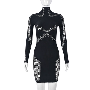 Détail d'une robe moulante noire à manches longues avec maille ajourée et col montant