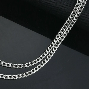 Close-up of polished silver stainless steel NK chain link showing metallic texture