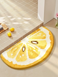 Detailed view of semi-circular lemon slice bath mat with thick absorbent flocking texture