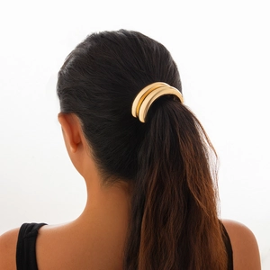 Golden double-ring geometric ponytail holder accessory in shiny polished metal finish
