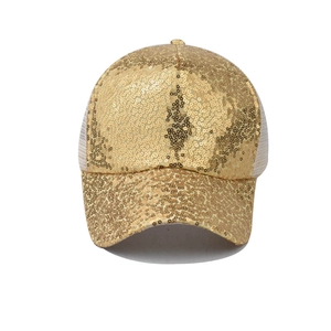 Close-up of golden sequins and white mesh detailing on a breathable baseball cap