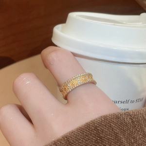 Macro shot of 24K gold plated zircon ring featuring a vintage embossed flower pattern