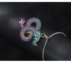 Macro view of a colorful dragon totem pendant on black leather textured surface