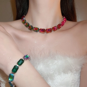 Close-up of rainbow square crystal necklace and bracelet set on model's neck and wrist