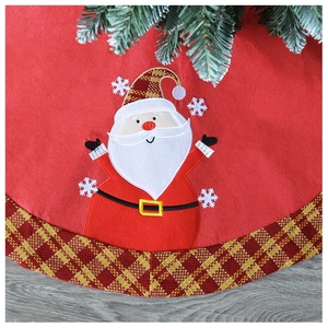 Close-up of red felt Christmas tree skirt featuring Santa applique and gold plaid border