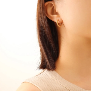 French style 18K gold plated titanium steel hoop earrings with textured finish on model