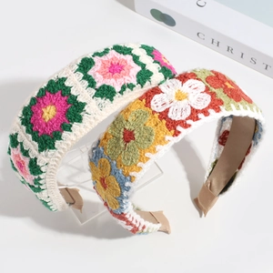 Detailed macro view of hand-knitted floral headband with colorful crochet stitch pattern