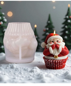 Macro view of 3D Santa Claus silicone mold and finished handmade Christmas candle