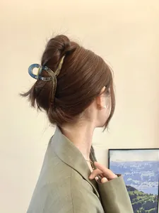 Detail of dark gray translucent large hair claw clip for French twist on model