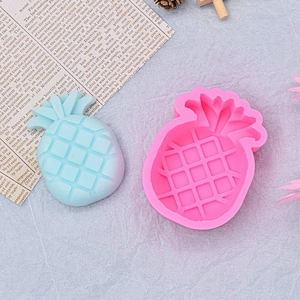 Pineapple shaped pink silicone mold with blue finished piece for DIY soap and baking