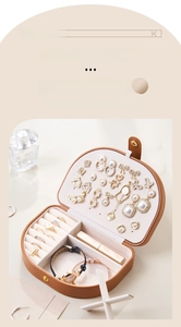Detail of jewelry box interior featuring gold clasp and detachable partition for watches