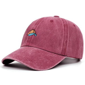 Detailed macro view of vintage washed burgundy cotton baseball cap with embroidered logo