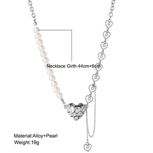 Detail of silver heart pendant necklace with pearls and textured hammer pattern