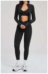 Close-up of black 3-piece fitness set with zip jacket, V-neck top, and crossover waist leggings
