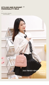 Detailed view of pink floral embossed mini backpack with gold buckle and magnetic flap