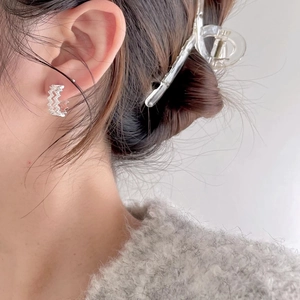 Elegant wavy S925 sterling silver hoop earrings with shimmering zircons on model