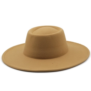 Detail of camel wool fedora hat featuring flat brim and oval indented crown top