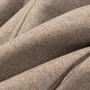 Detailed macro view of light brown wool blend fabric with professional stitching
