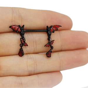 Detail of gothic black bat nipple ring with red enamel wings and crystal water teardrop pendants