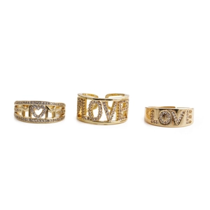 Detailed view of three gold-plated copper rings featuring MOM and LOVE zircon designs