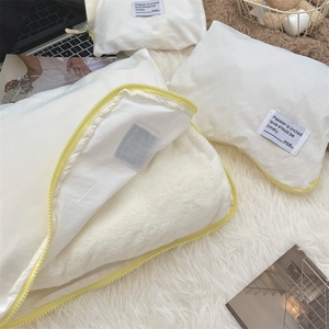 Detail of travel organizer bag featuring white fabric, yellow zipper and plush fleece lining