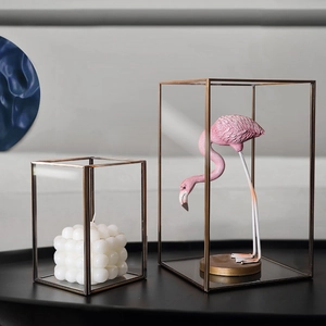 Modern gold geometric glass display case with flamingo model and bubble candle decor