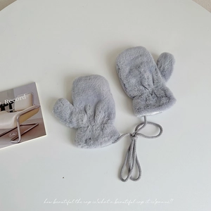 Close-up of grey plush winter mittens for kids featuring a neck string and soft faux fur