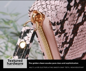 Detail of pink snakeskin wallet with smooth gold zipper and electroplated metal hardware