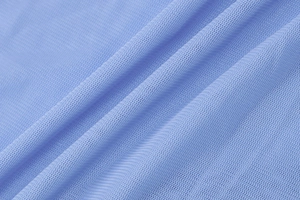 Macro view of light blue mesh fabric showing detailed knit texture and soft drapery