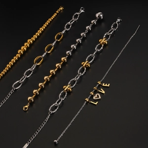 Detail of stainless steel bead bracelets with LOVE heart pendants in gold and silver