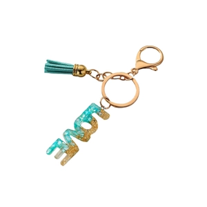 LOVE resin keychain with teal glitter, golden foil, fringe tassel and lobster clasp