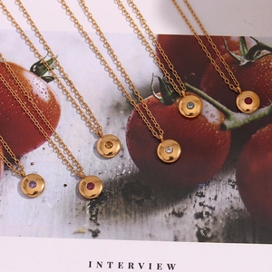 Detail of 18K gold-plated birthstone necklaces displayed on a lifestyle background