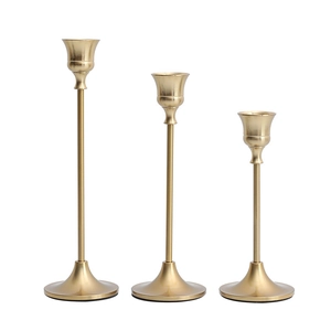 Set of 3 Nordic brass style candle holders in graduated heights with matte gold finish
