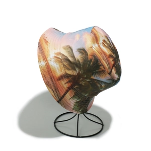 Detailed view of bucket hat featuring colorful tropical palm tree and sunset print