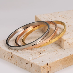 Three-piece textured bangles set in gold, rose gold, and silver finishes for couples