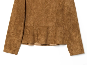 Detail of the brown suede jacket featuring a flared hemline and visible stitching lines