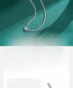 Macro detail of hand-set 5A cubic zirconia pendant on a minimalist silver chain necklace